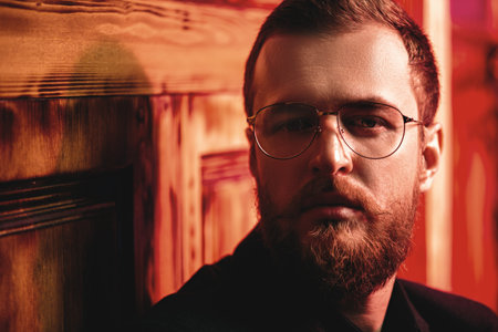 A portrait of a stylish man wearing glasses. Beauty and style for men.