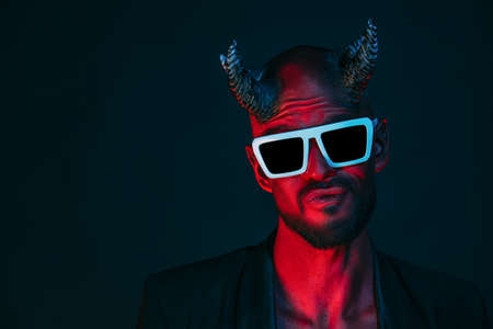 A portrait of a bad demon in sunglasses.の写真素材