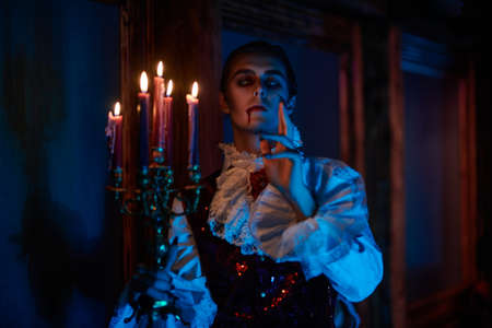 A bloodthirsty vampire aristocrat sneaks around the castle in the night in search of a victim. 19th century style. Halloween.の写真素材