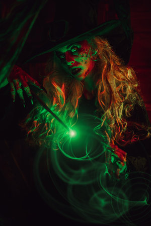 Horrible old witch casts a spell with a magic wand. Halloween. Scary tales.