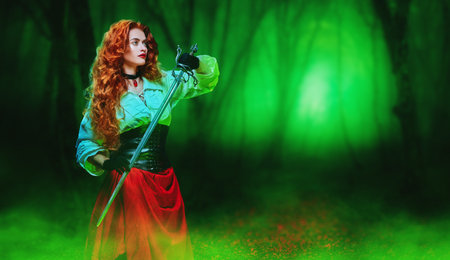 Portrait of a beautiful red-haired girl with a battle epee (rapier) standing in a magic forest. The...