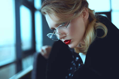 Portrait of a glamorous young woman in fashionable glasses. Beauty, fashion concept. Optics, eyewear.の写真素材