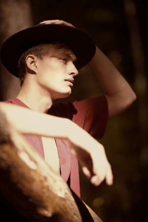 Portrait of a handsome young man in the autumn forest. Male beauty. Adventure, spirit of freedom. Active lifestyle.の写真素材