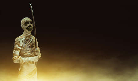 Scary mummy warrior with a sword on a dark background with a mystical haze. Halloween. Ancient Egyptian mythology.の写真素材