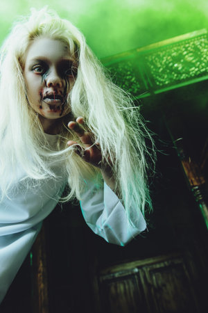 Portrait of a scary pale girl from a horror film in a room. Zombie, halloween.