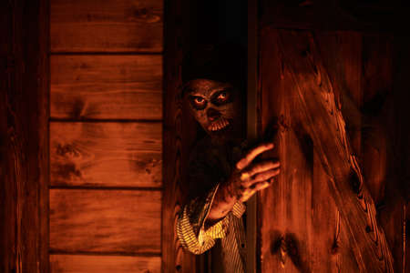 Dangerous bloodied zombie sneaks into the house. Halloween. Thriller.の写真素材