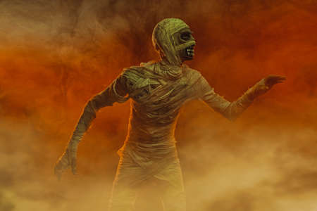 Scary evil mummy against the background of a sandstorm. Halloween. Ancient Egyptian mythology.の写真素材