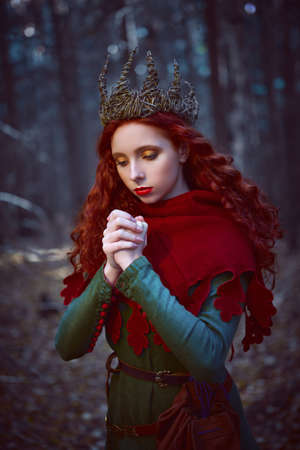 Fantasy world. Beautiful red-haired princess in a deep forest. Ancient times. Celts.の写真素材
