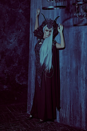A portrait of a stately and beautiful old woman with long gray hair, in a rich headdress and a rich...
