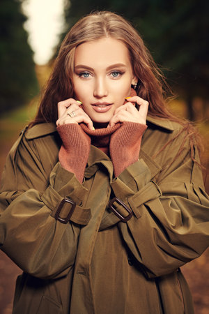 Autumn beauty woman. Portrait of a beautiful young woman in an autumn park. Autumn colors. Makeup...