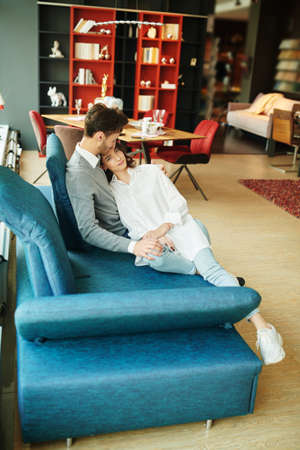 Beautiful young people in love spending time together at home. Happy couple. Home interior, furniture.の写真素材