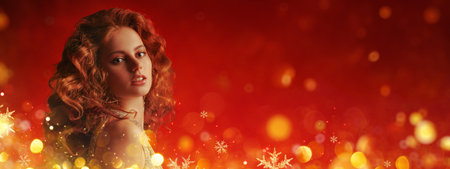 Holiday Christmas beauty. Portrait of a charming young woman with long curly red hair on a festive...