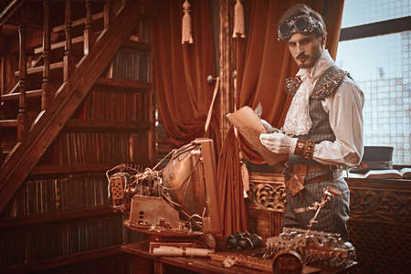 Scientist steampunk man inventor works in his laboratory with Victorian interior. Adventure world of steampunk.の写真素材