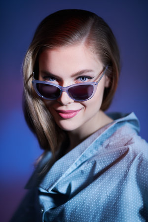 Portrait of a beautiful young woman in elegant glasses smiling at camera. Glasses fashion.の写真素材