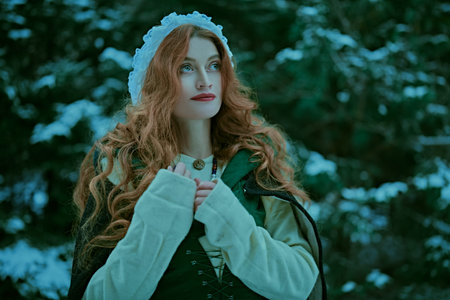 Portrait of a beautiful young woman with long red hair wearing medieval clothes walks through a...