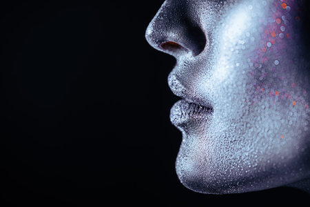 Body painting and makeup. Close-up side view portrait of a part of a woman's face with black painted...