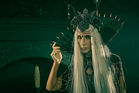 Fairy tale evil Queen, Witch. Portrait of a stately and beautiful old woman with long gray hair, in...