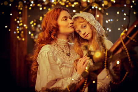 Beautiful red-haired woman gently hugs and kisses her little daughter on Christmas night. Christmas in the old days. Vintage style.の写真素材