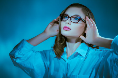Portrait of a beautiful young woman in elegant glasses. Glasses fashion. Business style.の写真素材