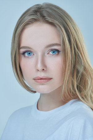 Portrait of a beautiful young woman with blonde hair and natural make-up. Studio shot on a white background. Beauty industry.の写真素材