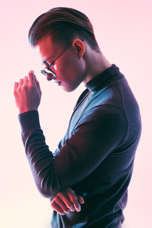 Men's accessories, optics. Profile portrait of a handsome young man in elegant glasses. Business style.の写真素材