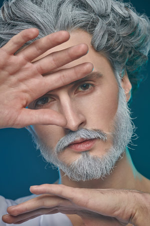 Divine man with a beard and curly hair on a blue background. Art image of God. Roman and Greek...