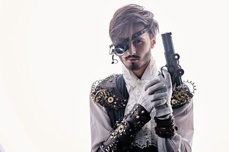 Portrait of a handsome noble man with steampunk gadgets and a gun on a white background. Steampunk...