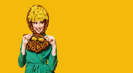 Portrait of a charming flirty woman posing in fashionable elegant clothes and with mimosa flowers on...