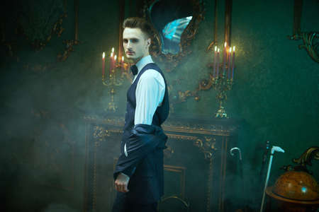 Portrait of a handsome man in elegant classic suit and a tie on a vintage background. Business style. Men's fashion.の写真素材