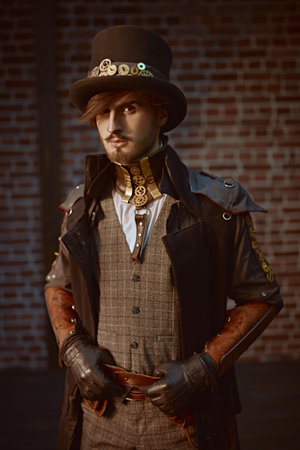 Portrait of a stylish steampunk nobleman in a coat and top hat on a brickwall background. Steampunk...