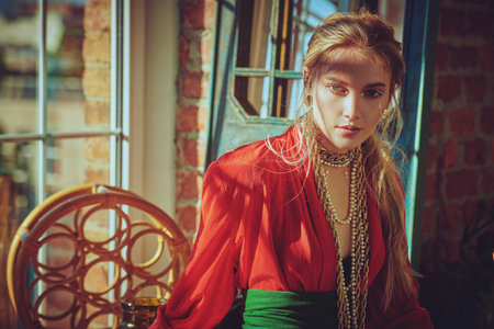 Attractive girl model poses in fashionable clothes and jewelry. Fashion shot. Make-up and cosmetics.