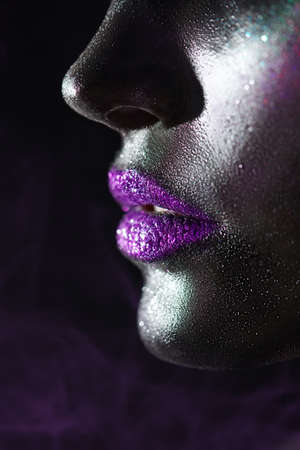 Art beauty portrait. Close-up portrait of of the lower part of the female face with a glamorous body art and make-up. Makeup and cosmetics.の写真素材