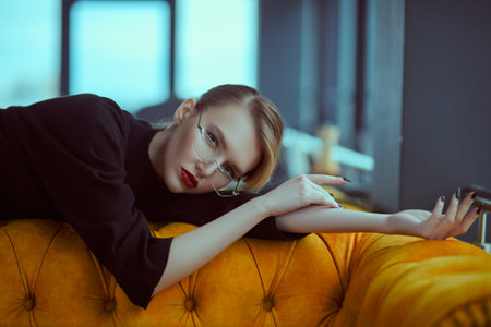 Beautiful girl with elegant romantic appearance in natural light is posing in the interior. Beauty,...