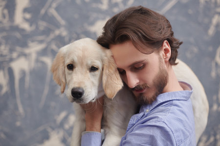 Portrait of a young man hugging his Golden Retriever dog. A man and a pet.