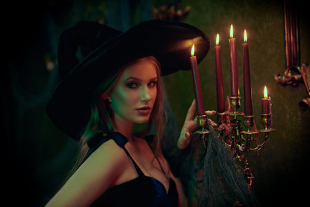 Portrait of a beautiful young witch in an old castle. Fairy tales. Halloween.