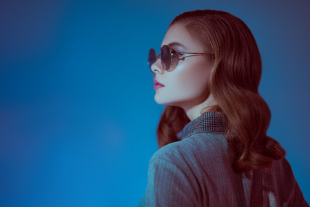 Portrait of a beautiful fashionable young woman in modern round sunglasses. Glasses fashion.