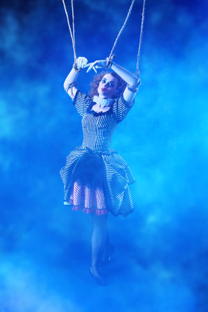 Puppet theater and circus. The actress plays a doll on strings at a performance in a puppet theater....