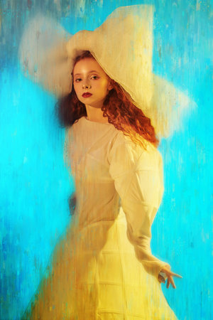 Sophisticated fashion model girl with lush red curly hair posing in a white haute couture dress and...