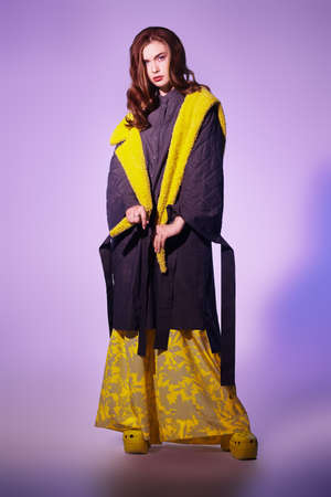 Haute couture clothing. Fashion model girl poses in stylish clothes from the spring-summer collection. Full length studio portrait.の写真素材