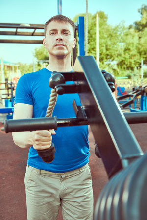Active healthy lifestyle. Handsome muscular man is training at outdoor gym.の写真素材