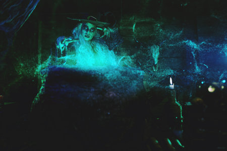 Halloween. Scary tales. Horrible old witch brews magic potion in her cauldron surrounded by magical...