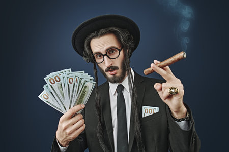 Portrait of a wealthy Jewish man with a gold ring on his finger and a bundle of banknotes, who...
