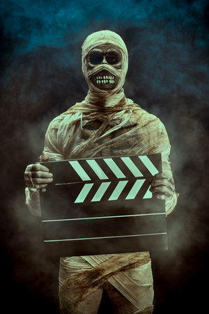 Adventure film. Portrait of a mummy holding a clapperboard on the set.の写真素材