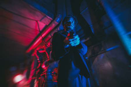 A wounded special agent drinks whiskey in a bar after completing a dangerous mission. Action movie hero.の写真素材