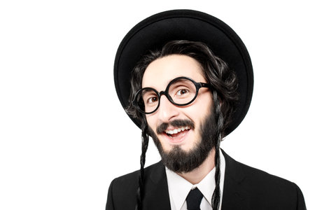 Portrait of a comical Orthodox Jewish man making faces. Studio shot on a white background with copy...