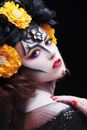 Sugar skull makeup. Portrait of Calavera Catrina in the light of a candle. Dia de los muertos. Day of The Dead. Halloween.の写真素材