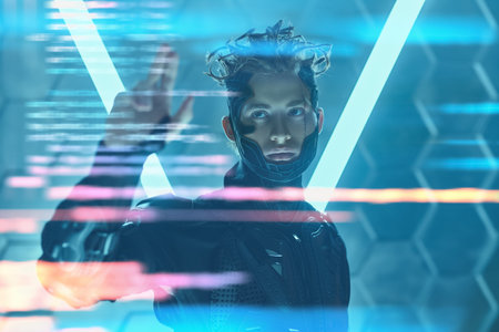 A handsome cyberpunk warrior in a protective uniform poses touching the virtual wall in neon light....