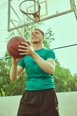 Portrait of a basketball player having basketball practice outdoor.