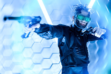 Militant cyberpunk warrior in a protective suit shooting his guns in a fight in neon light...