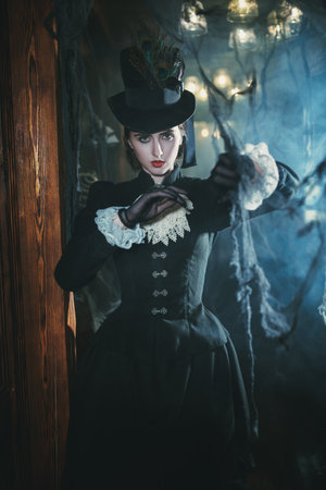 Curious young noblewoman in a 19th century dress wanders around an old vintage castle enveloped in mysterious white haze.の写真素材